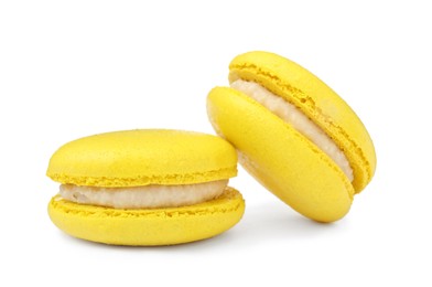 Photo of Yellow macarons on white background. Delicious dessert