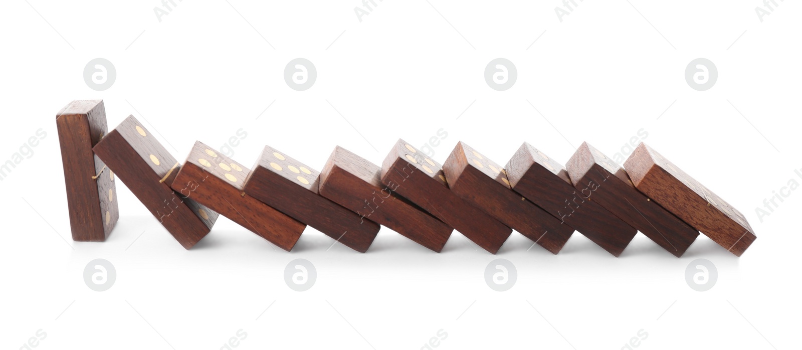 Photo of Wooden domino tiles falling on white background