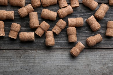 Sparkling wine bottle corks on wooden table, flat lay
