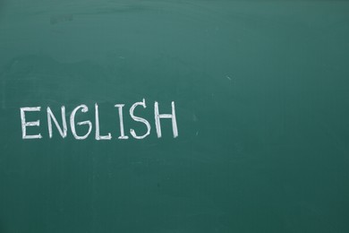 Photo of Word English written with chalk on green board. Space for text