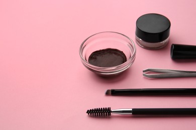 Eyebrow henna and professional tools on pink background, space for text