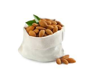 Photo of Sack with organic almond nuts and green leaves on white background. Healthy snack