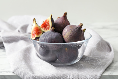 Whole and cut tasty fresh figs on table