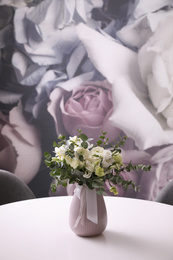 Vase with beautiful bouquet on white table indoors, space for text. Stylish interior element