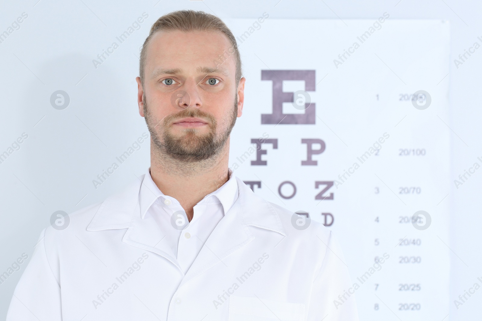 Photo of Male children's doctor near eye chart in hospital