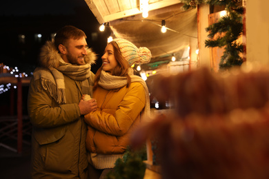 Photo of Happy couple spending time at Christmas fair