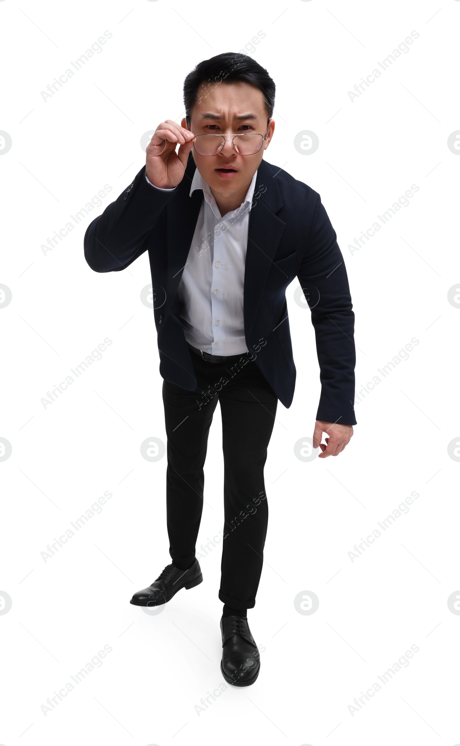 Photo of Angry businessman in suit wearing glasses on white background, low angle view