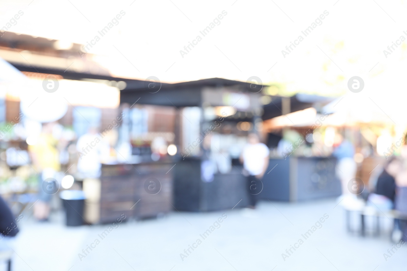 Photo of Blurred view of modern open air cafe on sunny day. Bokeh effect