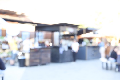 Photo of Blurred view of modern open air cafe on sunny day. Bokeh effect