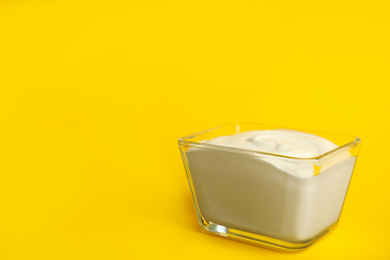 Photo of Tasty organic yogurt on yellow background. Space for text