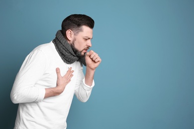 Photo of Mature man coughing on color background
