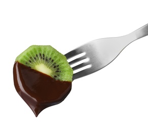 Kiwi with chocolate on fondue fork against white background