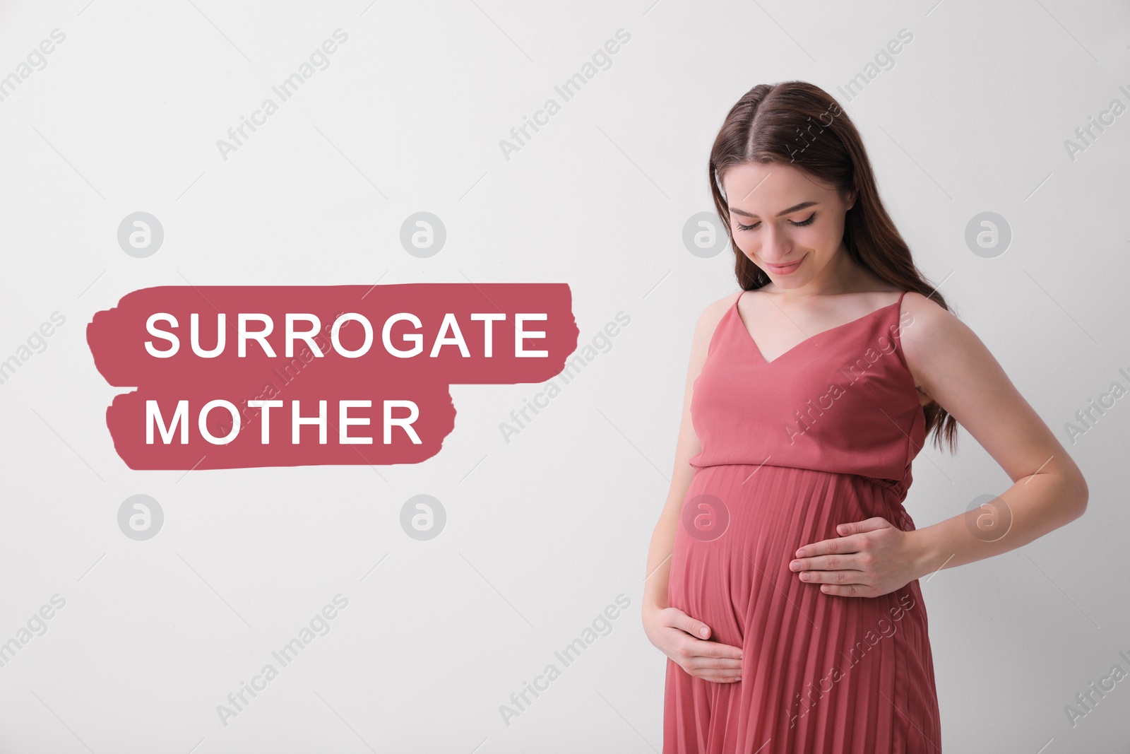 Image of Surrogate mother. Pregnant woman touching her belly on light background