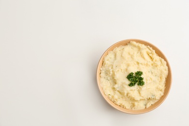 Photo of Bowl with tasty mashed potato on white background, top view