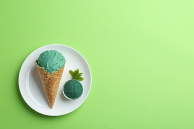 Photo of Flat lay composition with spirulina ice cream and space for text on color background