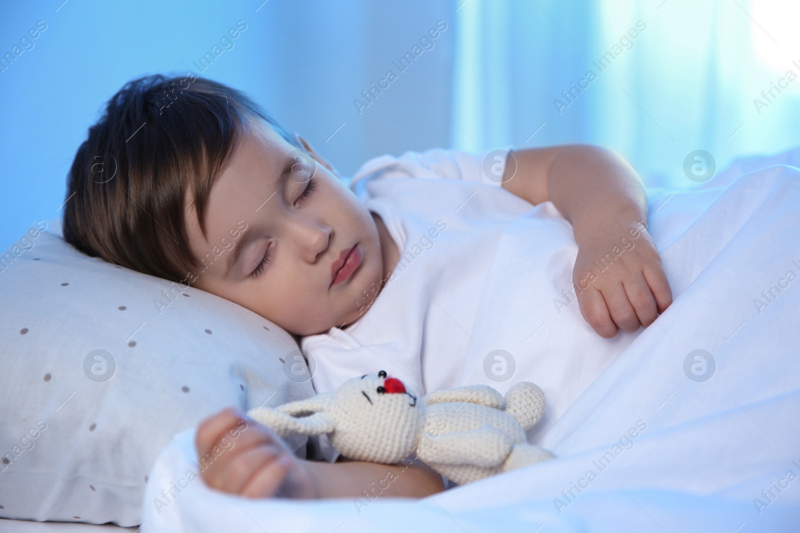 Photo of Cute little baby sleeping with toy at home. Bedtime