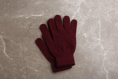Stylish gloves on light grey marble table, flat lay