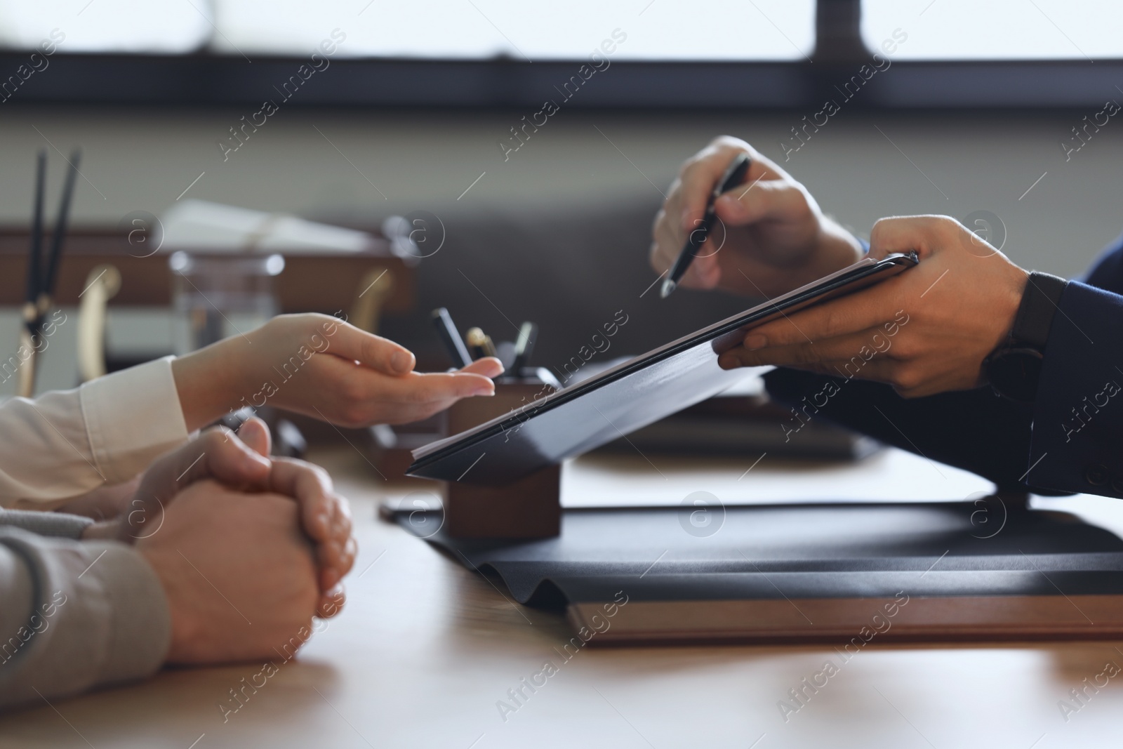 Photo of Male lawyer working with clients in office, closeup