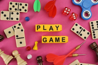 Photo of Flat lay composition of blocks with words Play Game on pink background