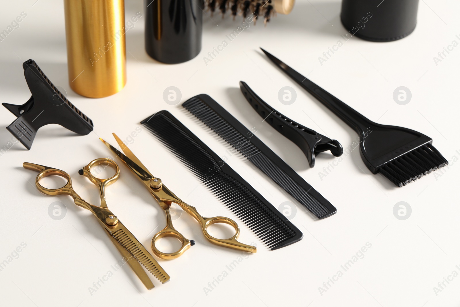 Photo of Hairdresser tools. Different scissors and combs on white table