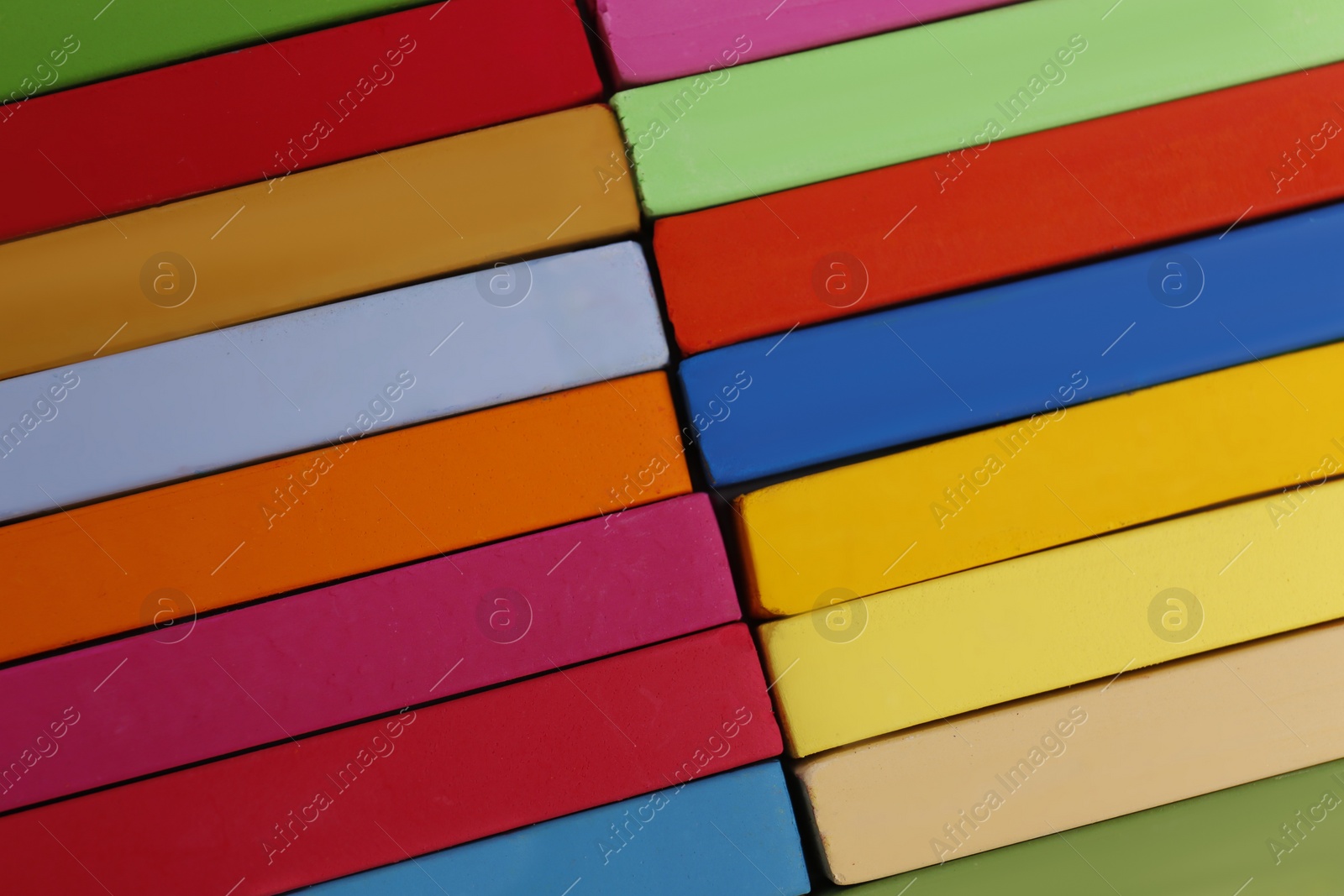 Photo of Set of colorful pastels as background, closeup. Drawing materials