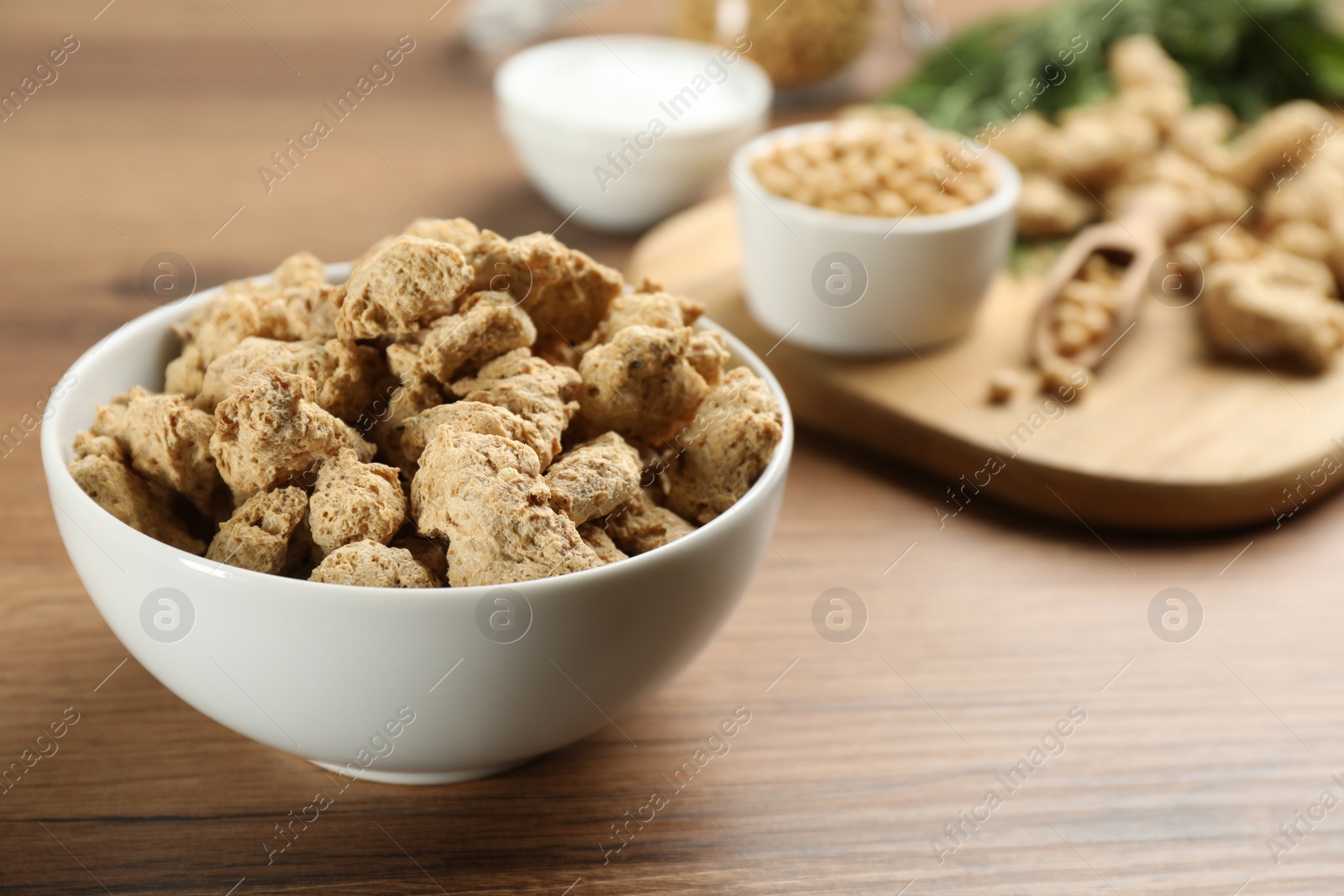 Photo of Dried soy meat on wooden table. Space for text