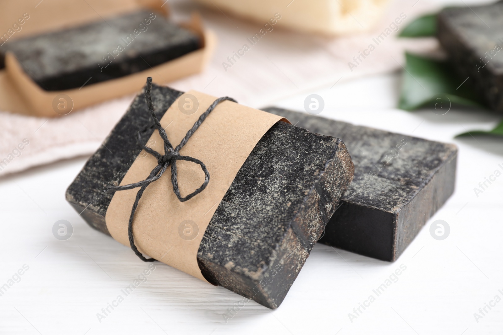 Photo of Natural tar soap on white table, closeup