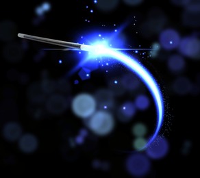 Image of Conjuring spell with magic wand on black background