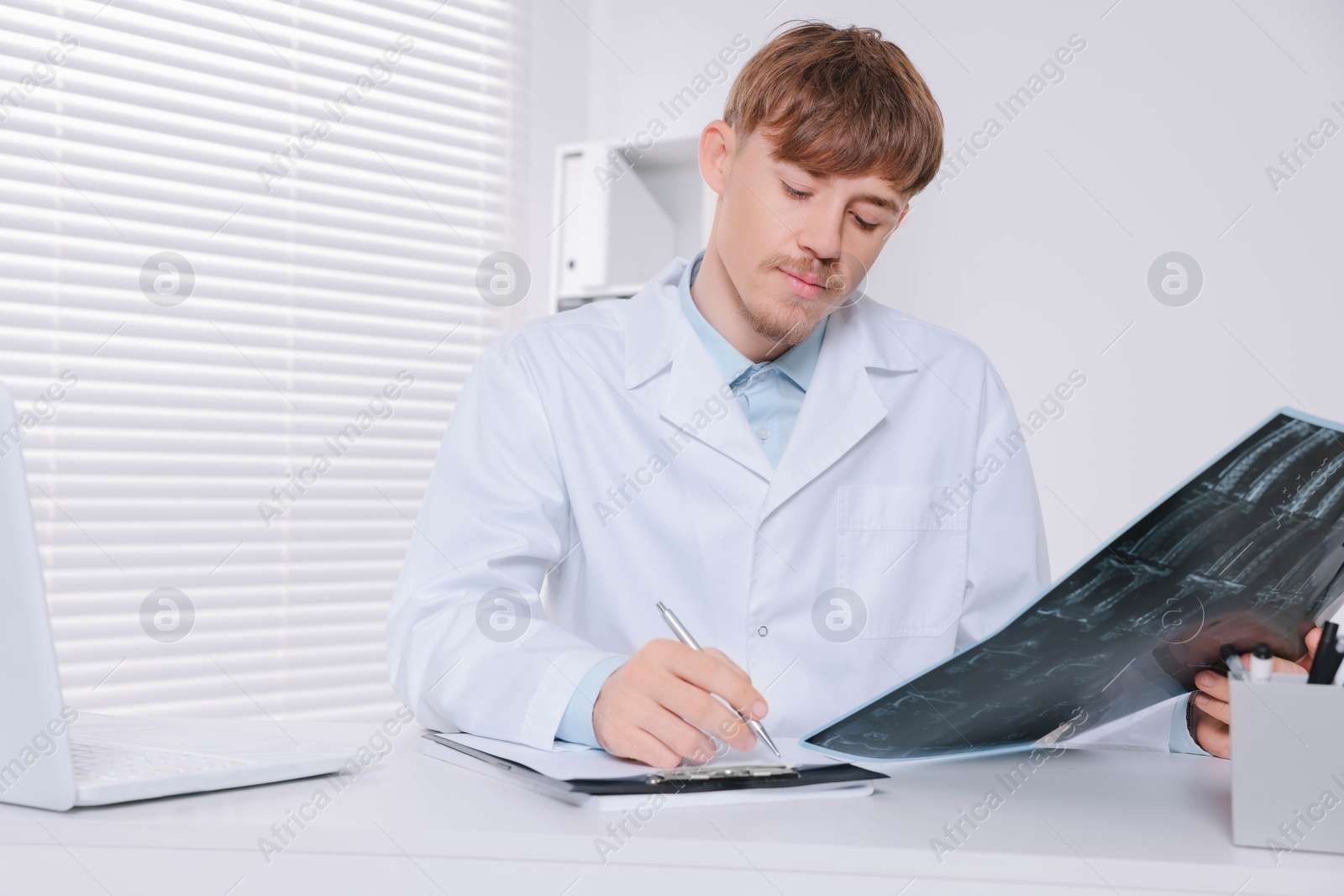 Photo of Doctor examining neck MRI image in clinic