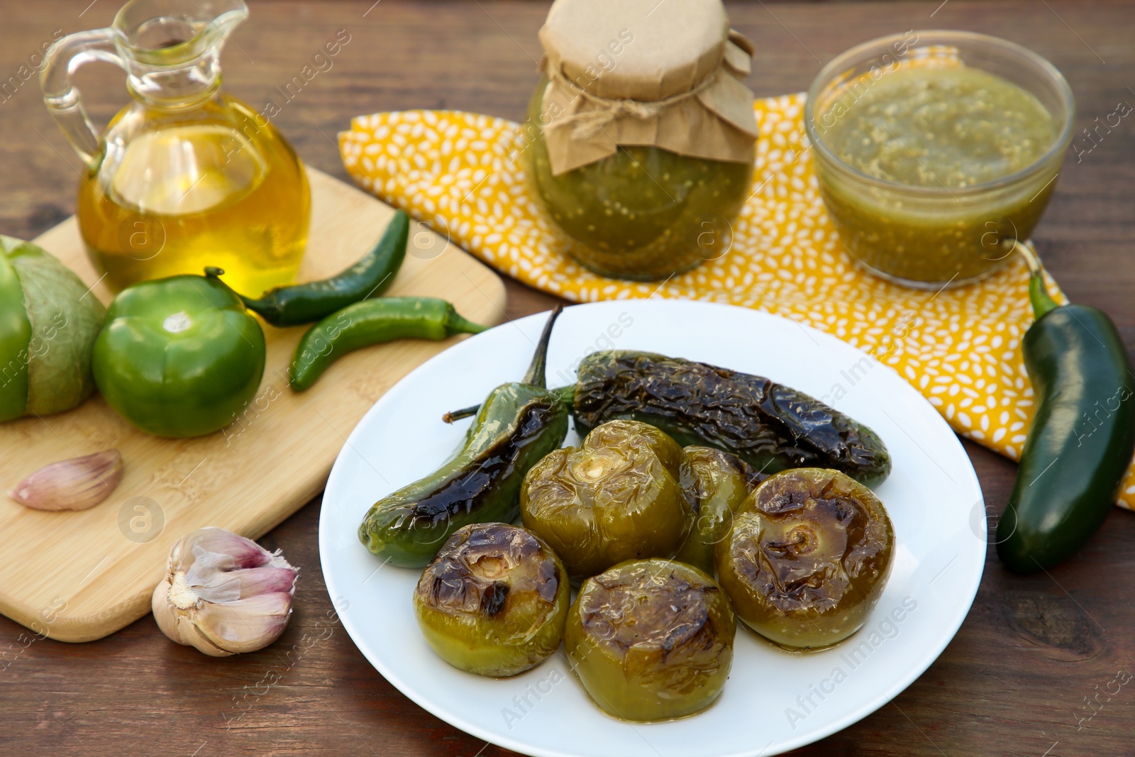 Photo of Different ingredients and tasty salsa sauce on wooden table