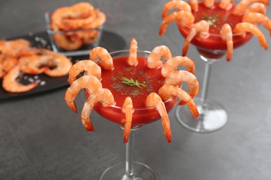 Delicious shrimp cocktail with tomato sauce on grey table