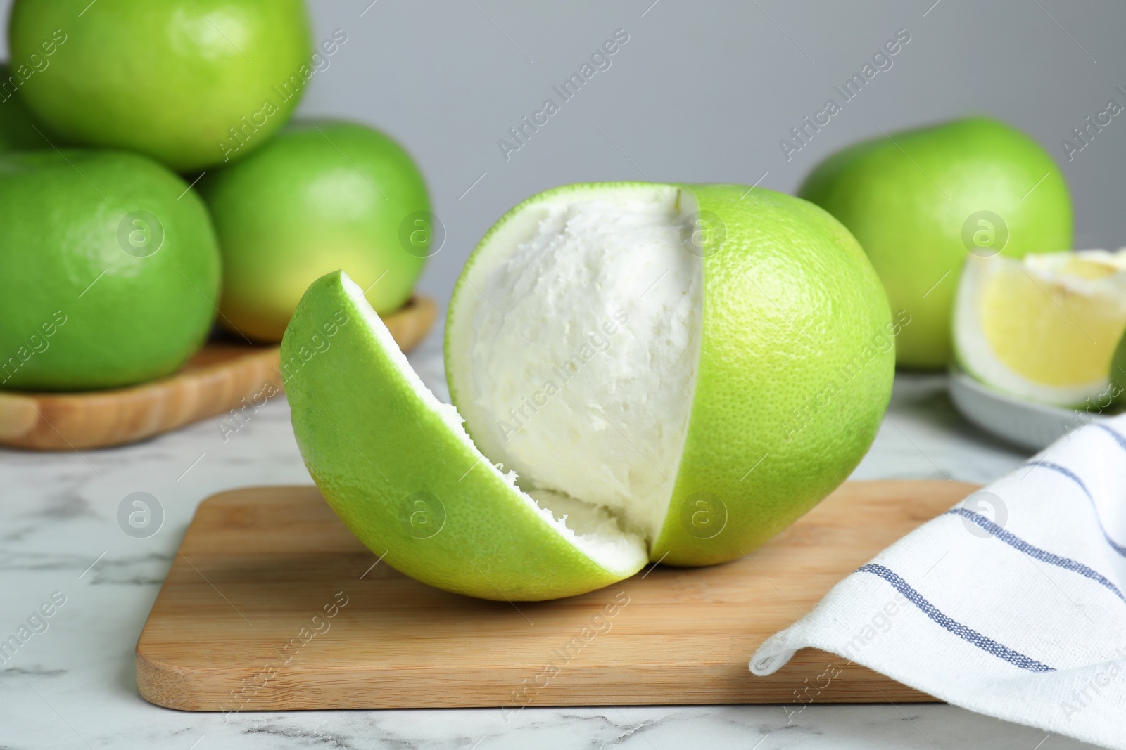 Photo of Fresh ripe sweetie fruit on white marble table