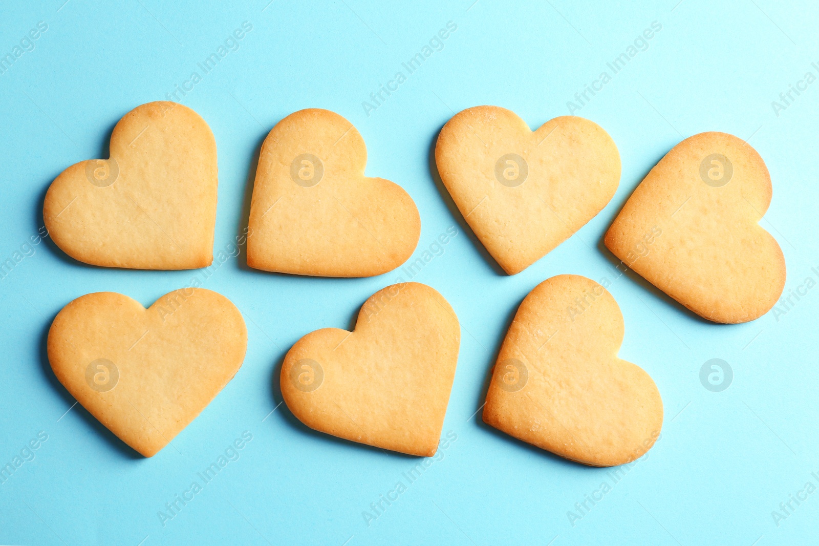 Photo of Homemade heart shaped cookies on color background, top view