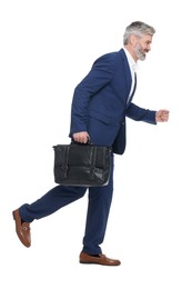 Mature businessman with briefcase walking on white background