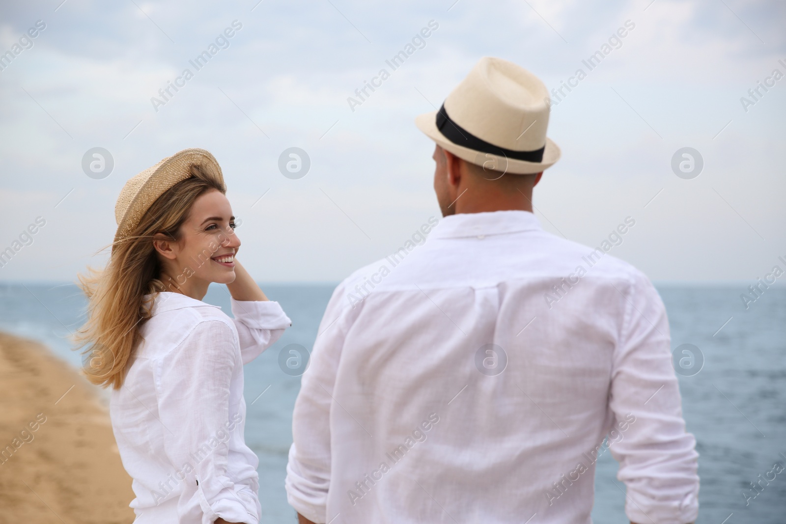 Photo of Happy couple having romantic walk on beach