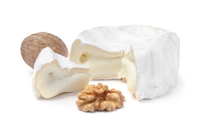 Photo of Tasty cut brie cheese with walnuts on white background