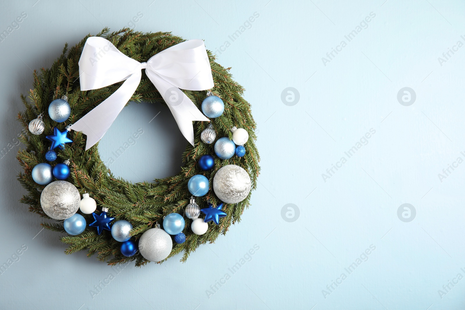 Photo of Beautiful Christmas wreath on light background, top view. Space for text