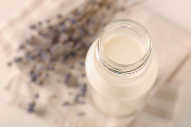 Bottle of tasty milk on light table, above view. Space for text