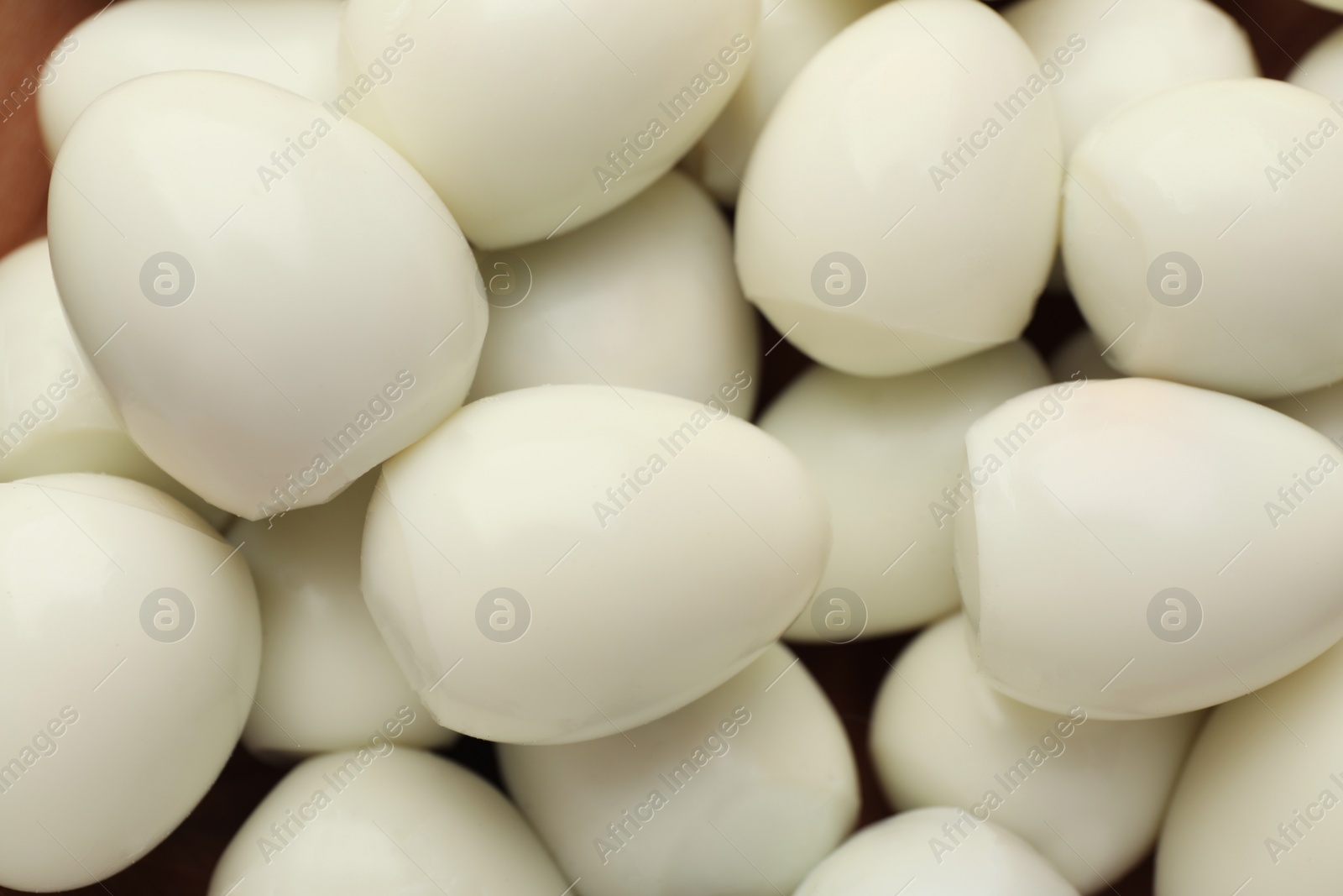 Photo of Peeled boiled quail eggs as background, top view