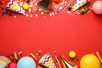Photo of Beautiful flat lay composition with festive items on red background, space for text. Surprise party concept