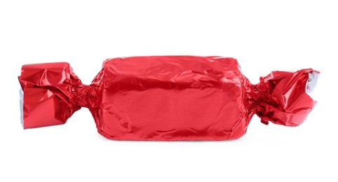 Photo of Tasty candy in red wrapper isolated on white