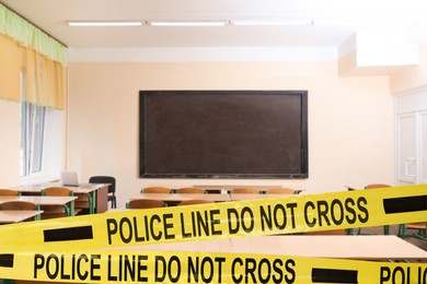 Yellow crime scene tape in empty school classroom