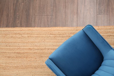 Photo of Stylish blue armchair on floor, top view. Space for text
