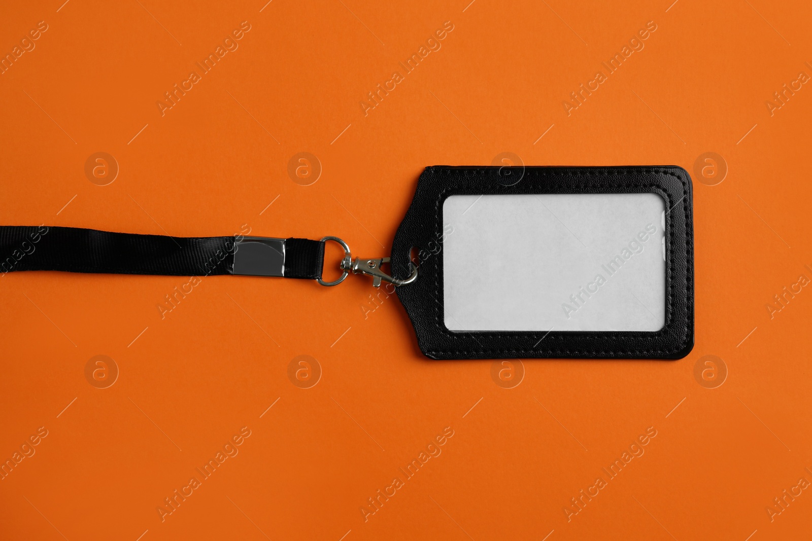 Photo of Blank badge on orange background, top view. Mockup for design