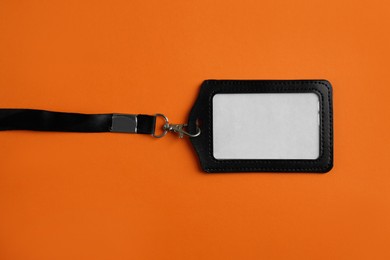 Blank badge on orange background, top view. Mockup for design