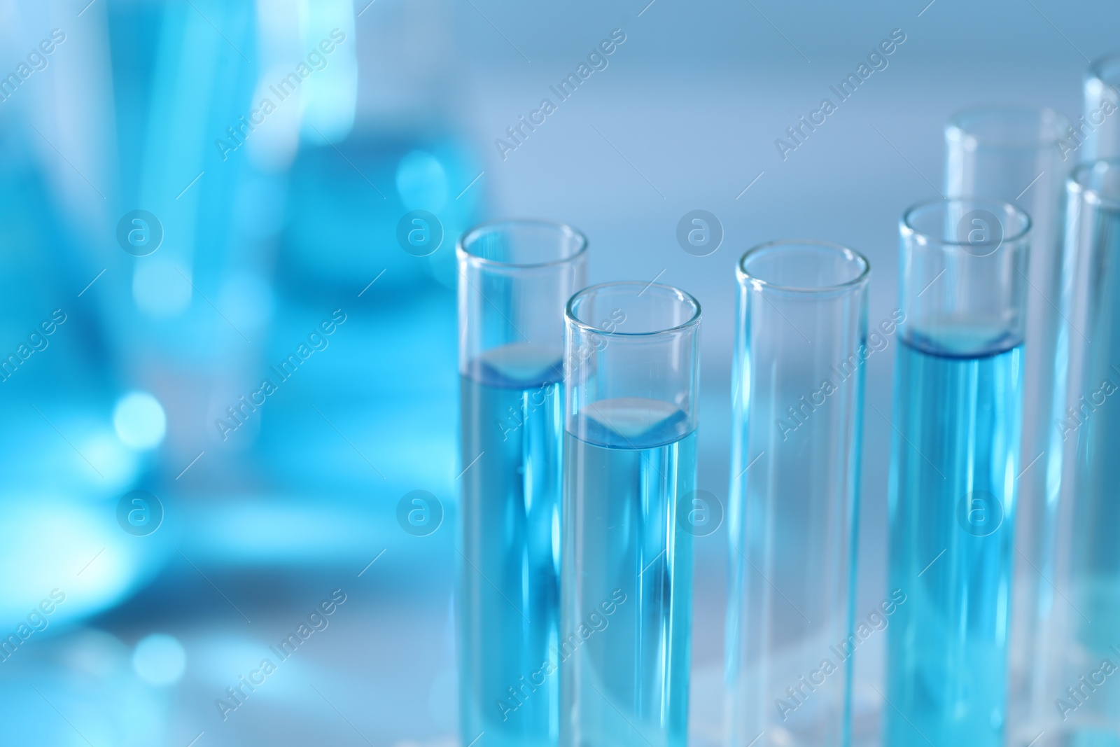 Photo of Test tubes with light blue liquid in laboratory, closeup