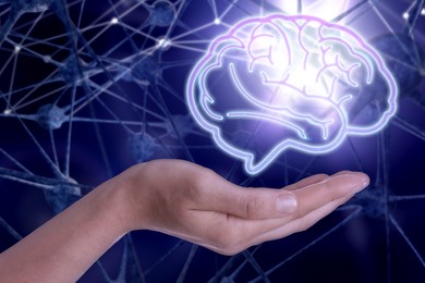 Image of Memory. Woman holding illustration of brain against neural network, closeup