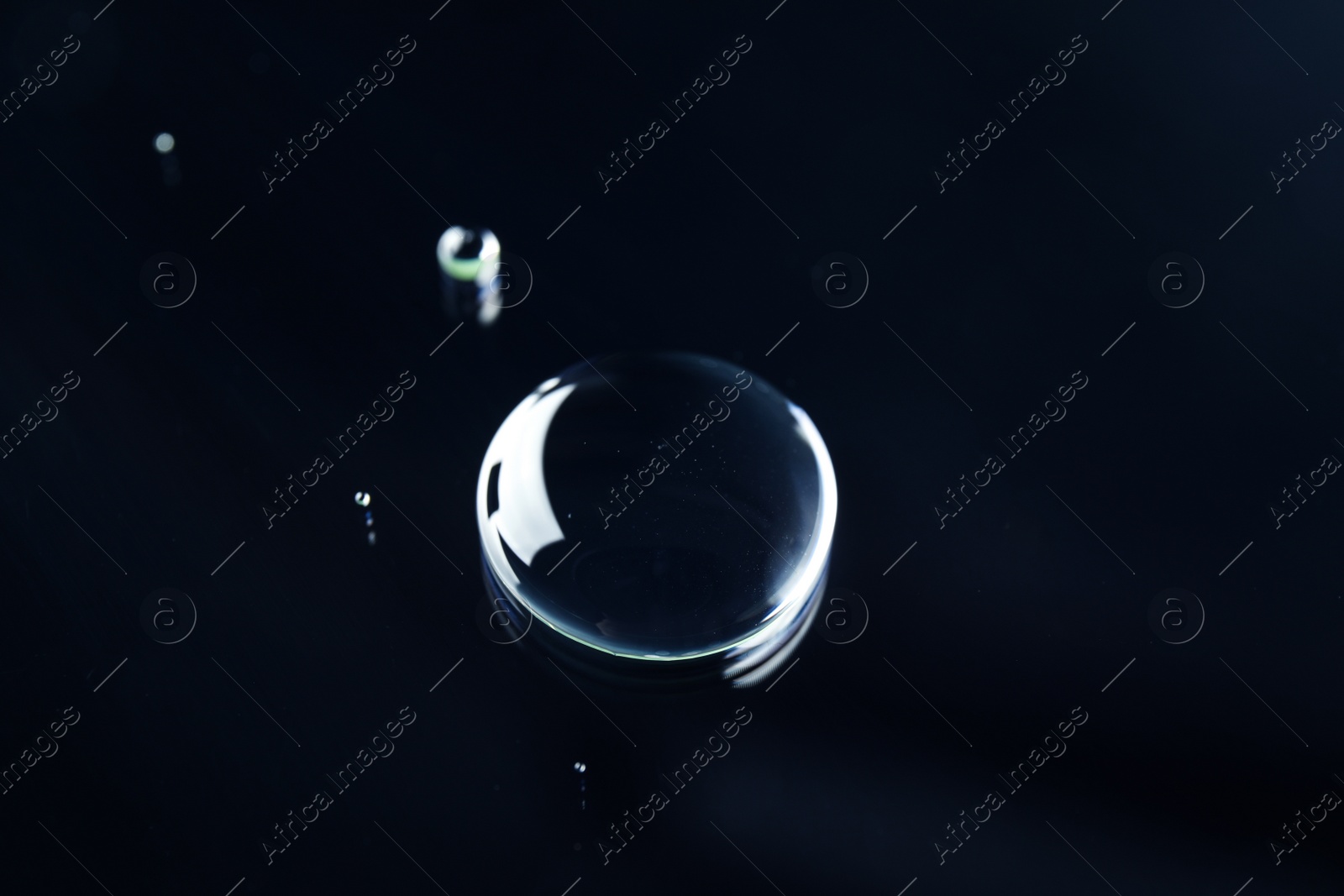 Photo of Beautiful clean water drops on black background
