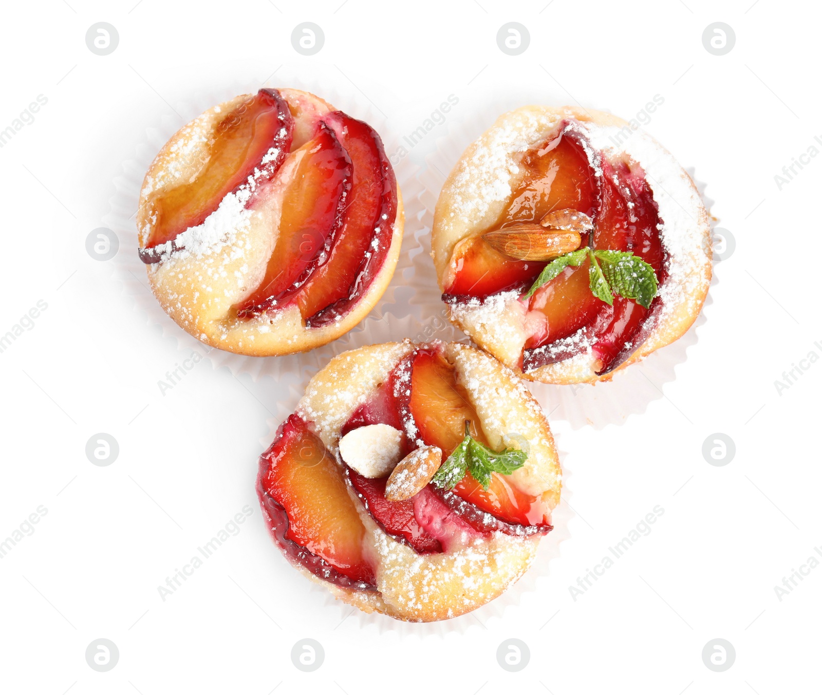 Photo of Delicious cupcakes with plums isolated on white, top view