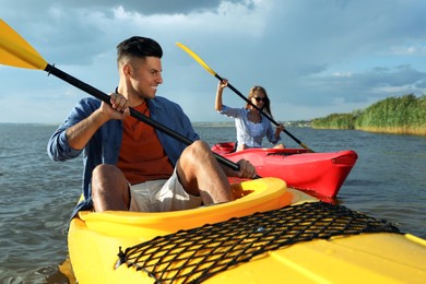 Beautiful couple kayaking on river. Summer activity